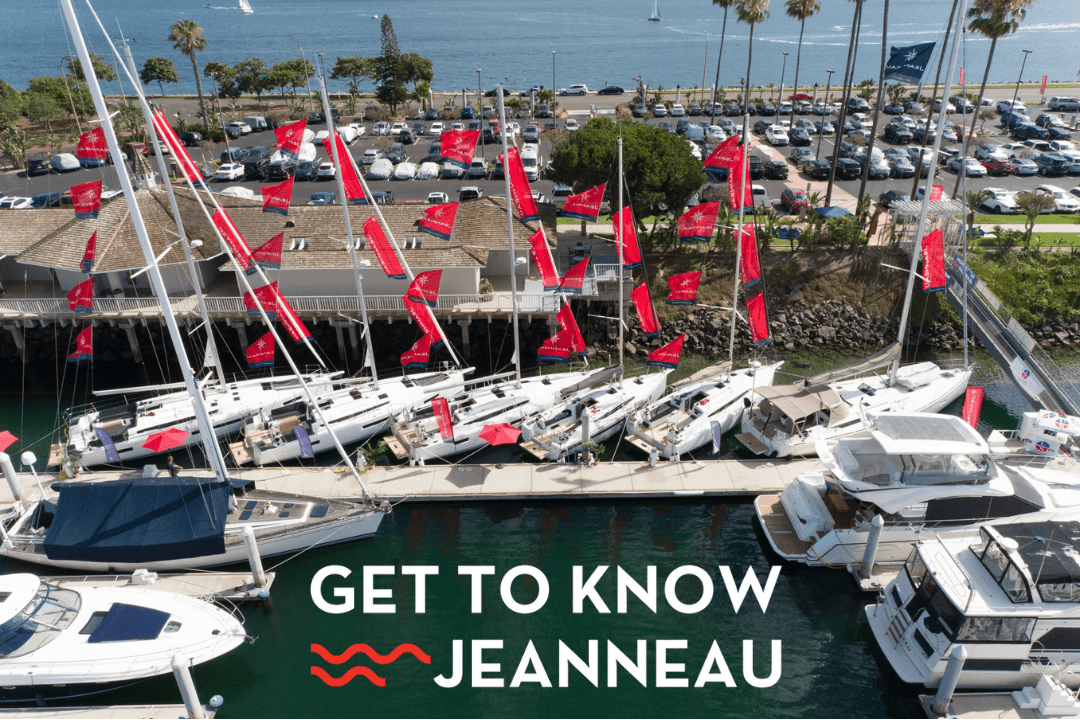 jeanneau sailboats decorated with red flags and the get to know jeanneau event logo