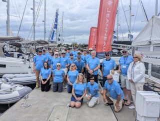 jeanneau owners all wearing the 2024 jeanneau summer rendezvous tshirt in a group photo at the event